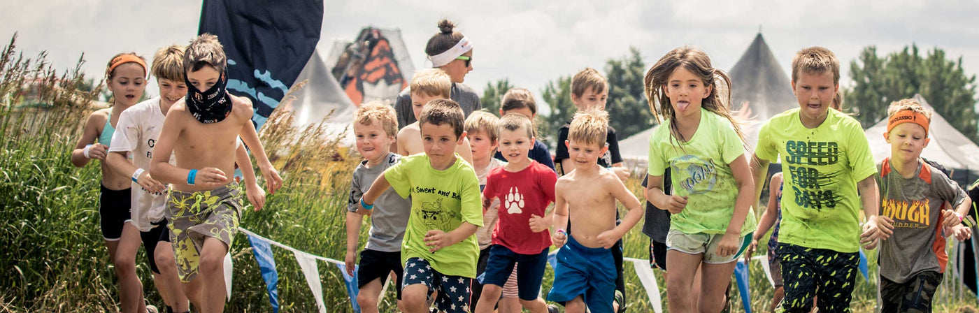 A group of children running at a Tough Mudder event